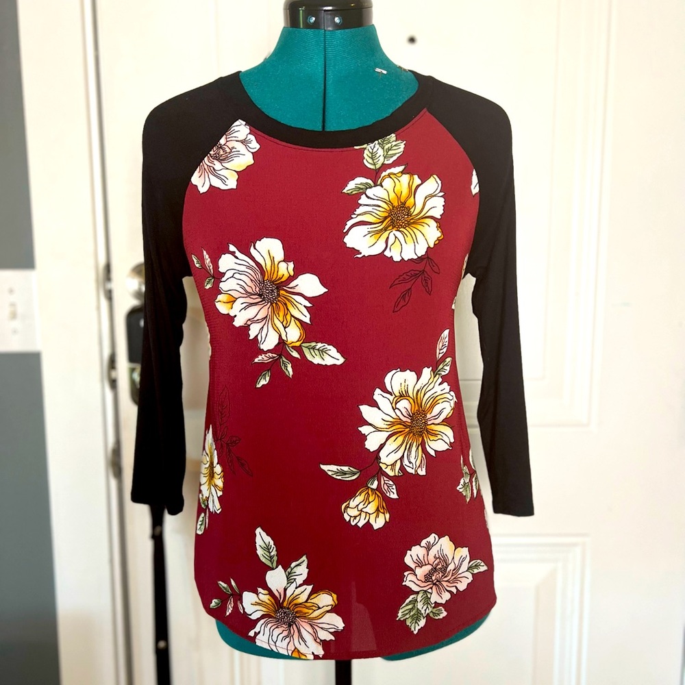 Lovely floral shirt with soft black sleeves that have slight stretch.